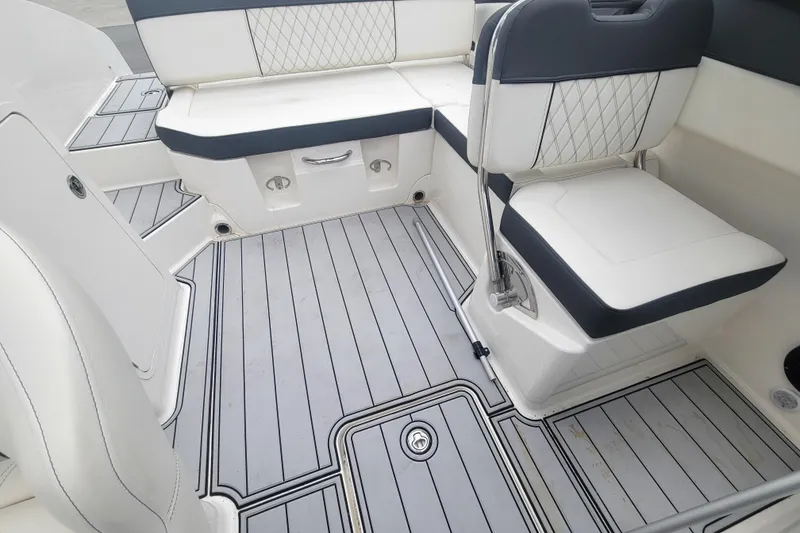 Slide: The Image of 2023 Bayliner DX 2200 boat interior with sleek seating and modern flooring design. - 11