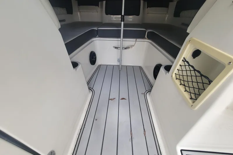 Slide: The Image of 2023 Bayliner DX 2200 boat interior with cushioned seating and storage compartments. - 12
