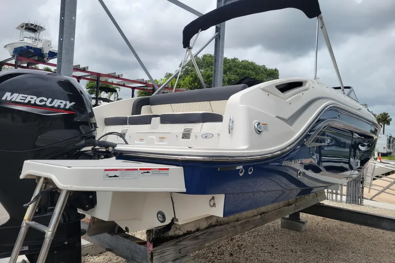 Slide: The Image of 2023 Bayliner DX 2200 boat with Mercury engine on display at marina. - 4