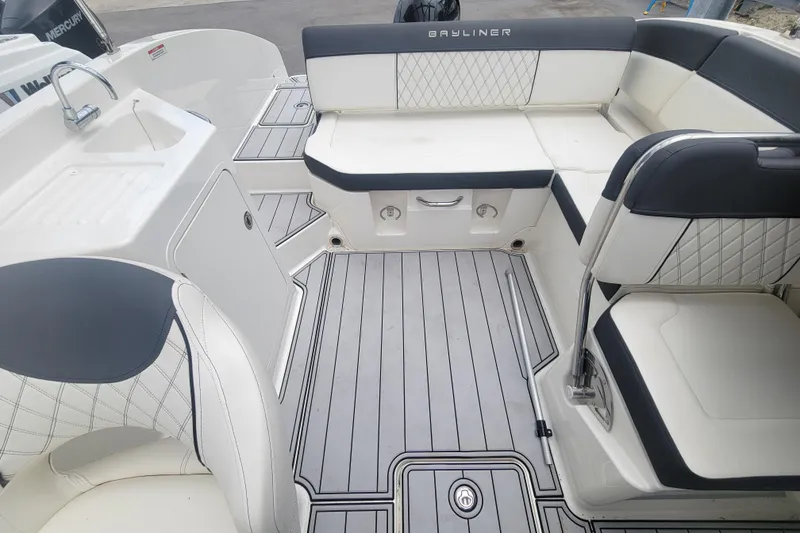 Slide: The Image of 2023 Bayliner DX 2200 boat interior with seating and sink, featuring modern design. - 7