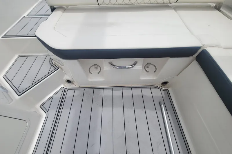 Slide: The Image of 2023 Bayliner DX 2200 boat interior with cushioned seating and sleek flooring design. - 8