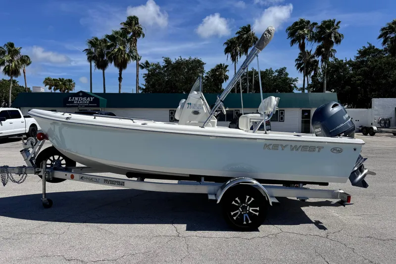 Slide: The Image of 2026 Key West 1720 Center Console boat on trailer, parked outdoors under clear sky. - 10