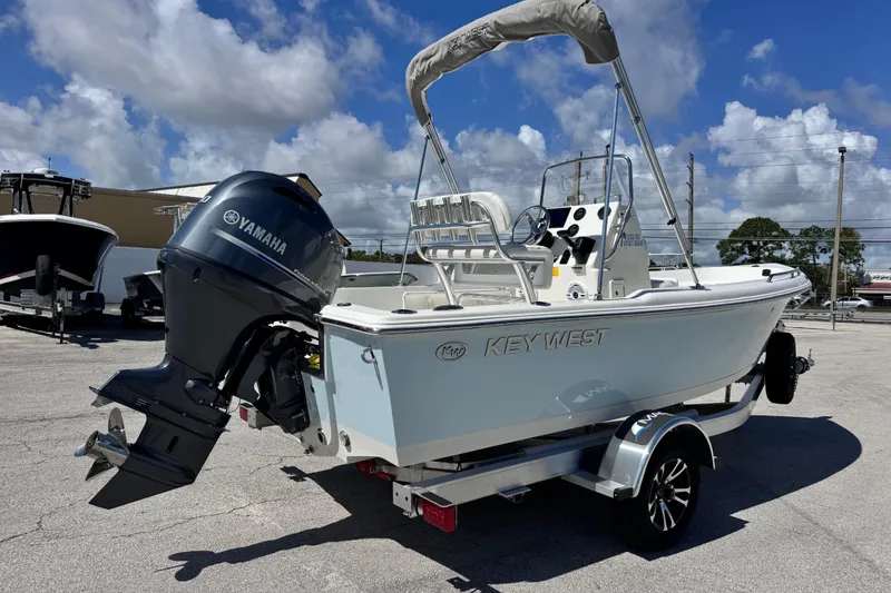 Slide: The Image of 2026 Key West 1720 Center Console boat with Yamaha engine on trailer under blue sky. - 13