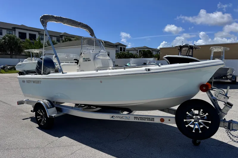 Slide: The Image of 2026 Key West 1720 Center Console boat on trailer, parked outdoors under clear sky. - 15
