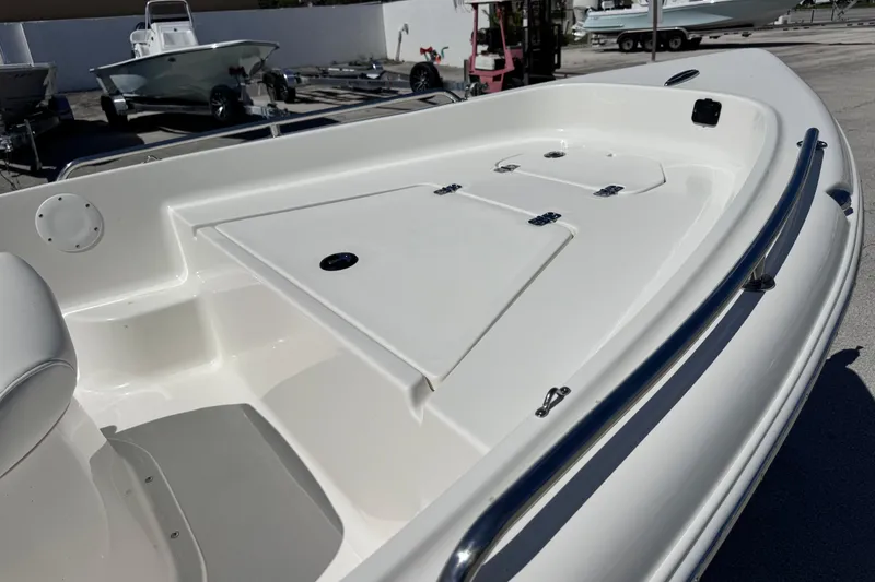 Slide: The Image of 2026 Key West 1720 Center Console boat deck with storage compartments and railings. - 16