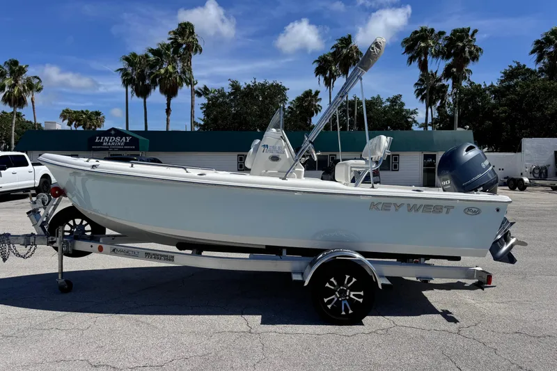 The Image of 2026 Key West 1720 Center Console boat on trailer, parked outdoors under blue sky. - 9