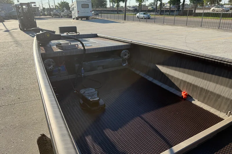 Slide: The Image of 2023 Gator Tail 1852 boat interior with equipment, parked outdoors. - 10