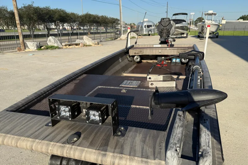 Slide: The Image of 2023 Gator Tail 1852 boat with advanced lighting and motor, parked outdoors. - 11