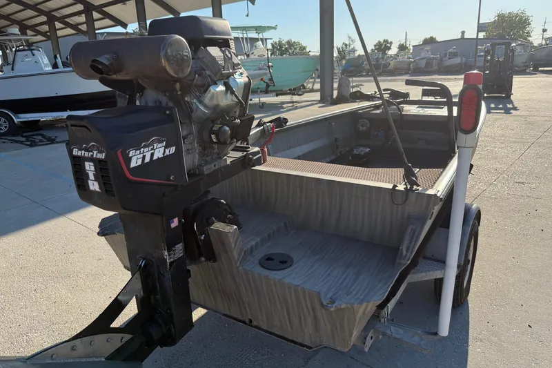 Slide: The Image of 2023 Gator Tail 1852 boat with GTR XD motor on trailer in marina setting. - 4