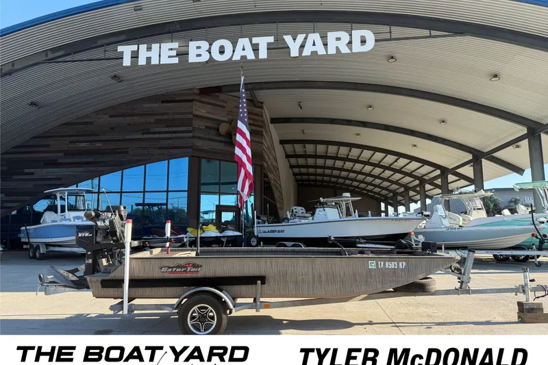 Slide: The Image of 2023 Gator Tail 1852 boat interior with equipment, parked in a lot. - 9