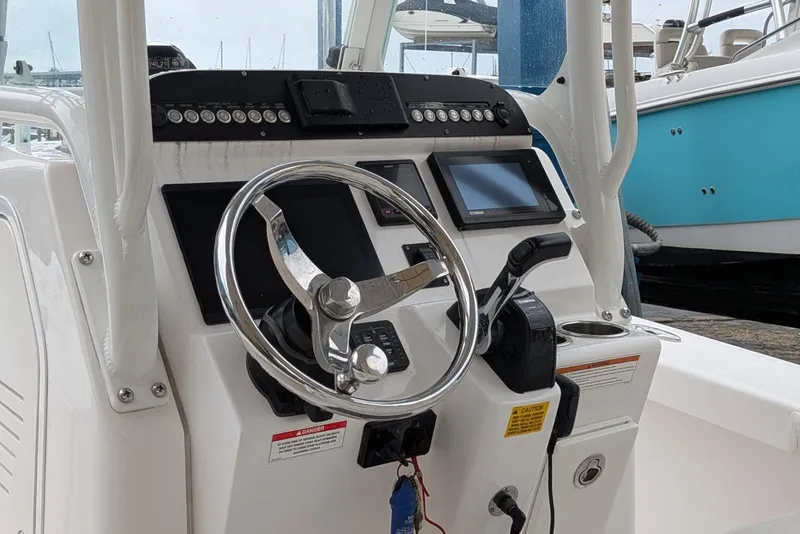 Slide: The Image of Steering console of 2020 Everglades 243 Center Console boat with modern controls. - 10