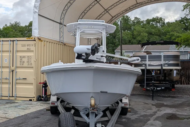 Slide: The Image of 2020 Everglades 243 Center Console boat on trailer under canopy. - 4