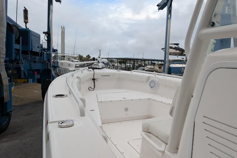 Slide: The Image of 2020 Everglades 243 Center Console boat docked at a marina under cloudy skies. - 8
