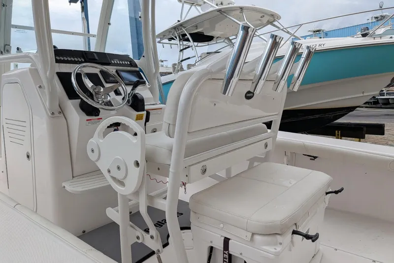 Slide: The Image of 2020 Everglades 243 Center Console boat interior with steering wheel and seating. - 9