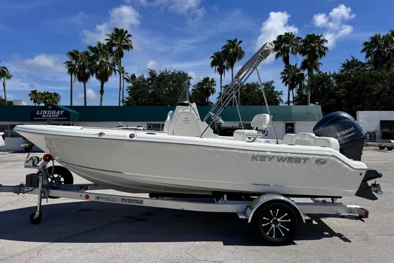 Slide: The Image of 2026 Key West 189 FS boat on trailer, parked outdoors under clear sky. - 13