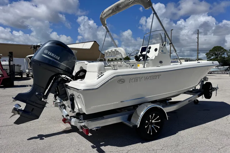 Slide: The Image of 2026 Key West 189 FS boat with Yamaha engine on trailer under blue sky. - 16