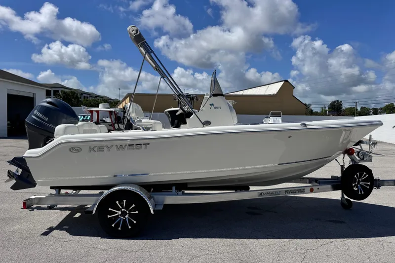 Slide: The Image of 2026 Key West 189 FS boat on trailer under a clear blue sky. - 17