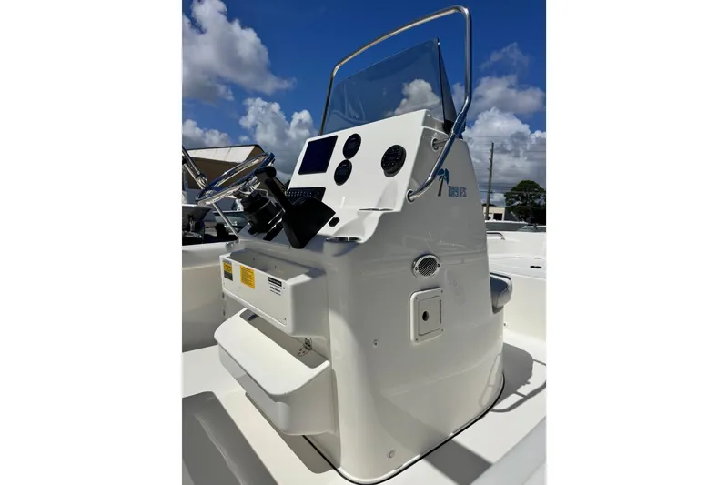 Slide: The Image of 2026 Key West 189 FS boat console with steering wheel and controls under blue sky. - 21