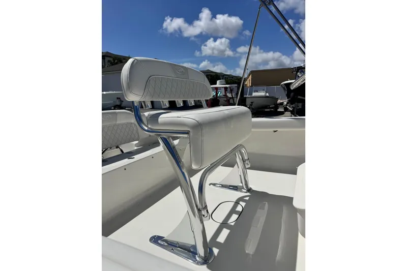 Slide: The Image of 2026 Key West 189 FS boat seat with chrome frame under a clear blue sky. - 22