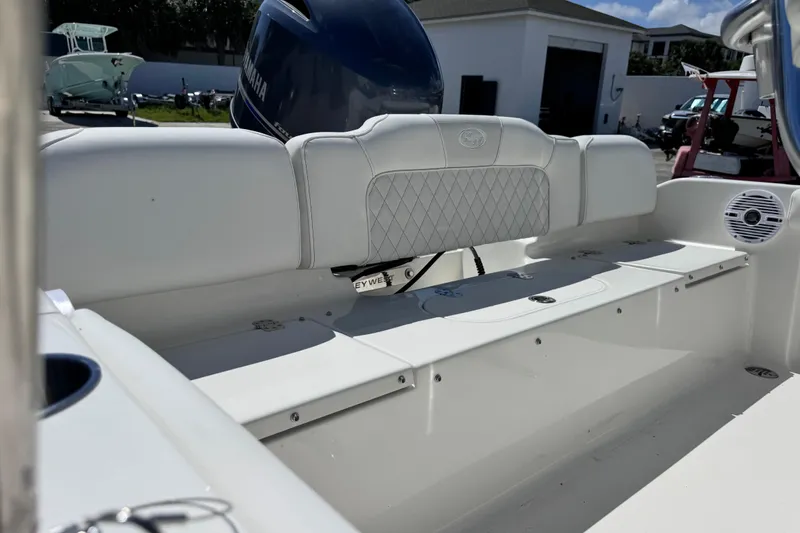 Slide: The Image of 2026 Key West 189 FS boat interior with white seating and Yamaha engine. - 23