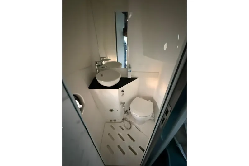 Slide: The Image of Compact bathroom in 2023 Schaefer 400 Sport yacht, featuring modern sink and toilet. - 12