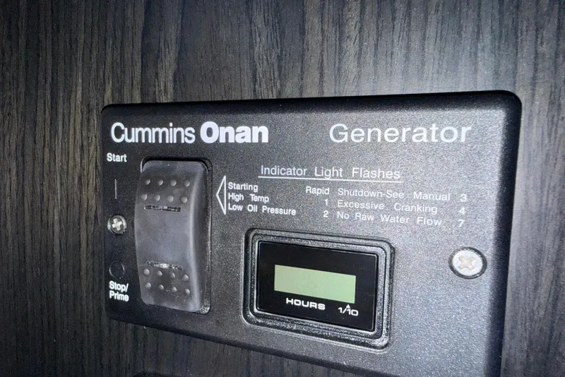 Slide: The Image of Cummins Onan generator control panel on 2023 Schaefer 400 Sport boat. - 13