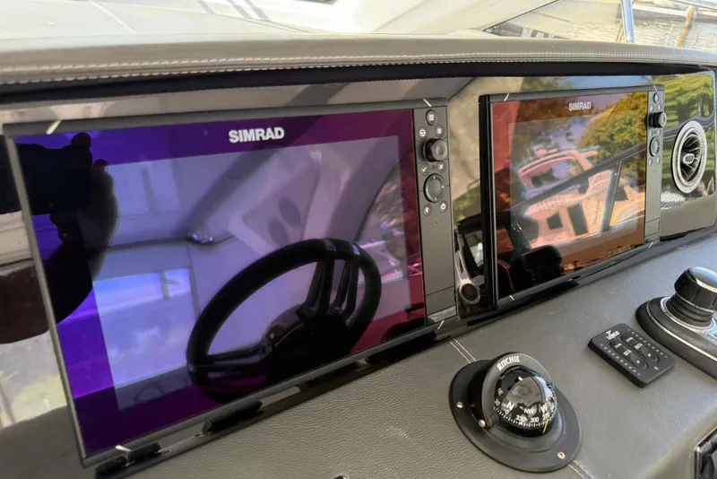 Slide: The Image of Dashboard of 2023 Schaefer 400 Sport with Simrad navigation displays. - 15