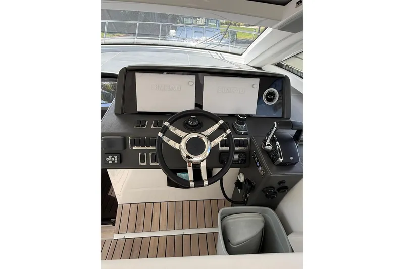 Slide: The Image of Helm of 2023 Schaefer 400 Sport yacht with modern controls and dual displays. - 5