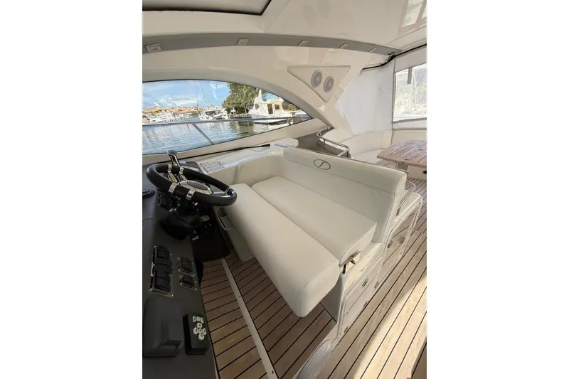 Slide: The Image of Interior of 2023 Schaefer 400 Sport yacht with white seating and wooden flooring. - 6