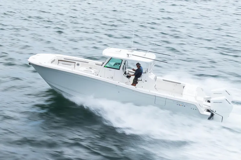 Slide: The Image of 2024 Caymas 341 CC boat cruising swiftly on open water. - 18
