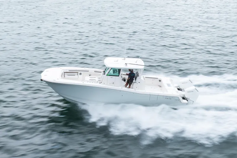 Slide: The Image of 2024 Caymas 341 CC boat cruising swiftly on open water. - 19