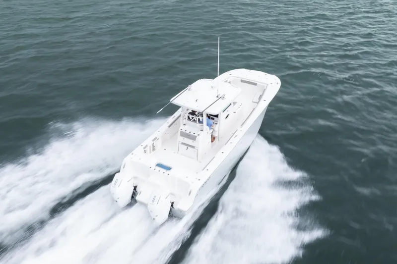 Slide: The Image of 2024 Caymas 341 CC boat cruising swiftly on open water. - 4