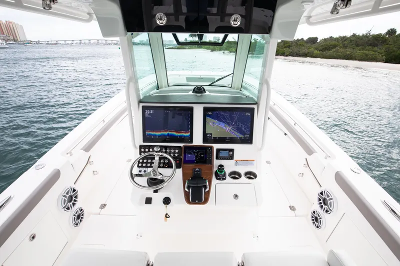 Slide: The Image of 2024 Caymas 341 CC boat cockpit with advanced navigation displays and steering wheel. - 5