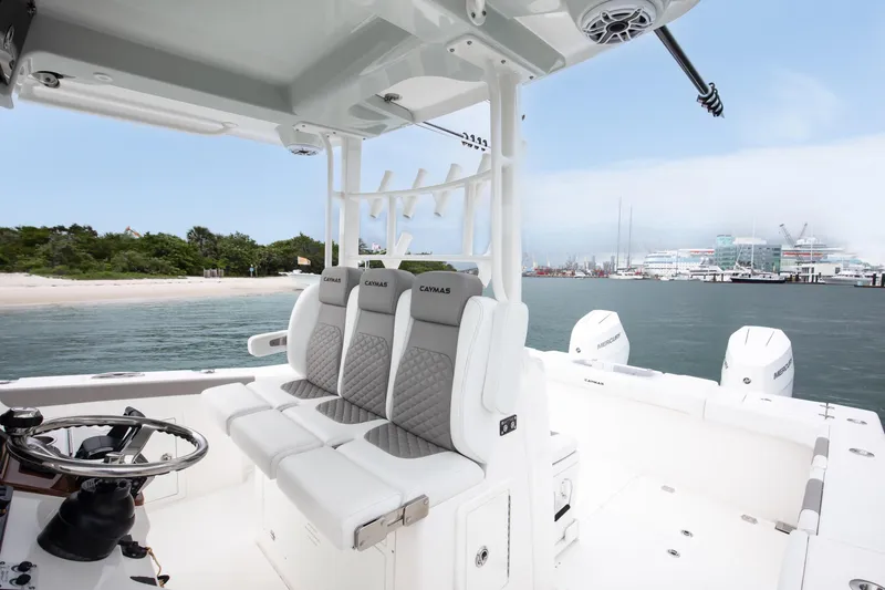 Slide: The Image of 2024 Caymas 341 CC boat interior with seating, steering wheel, and ocean view. - 7