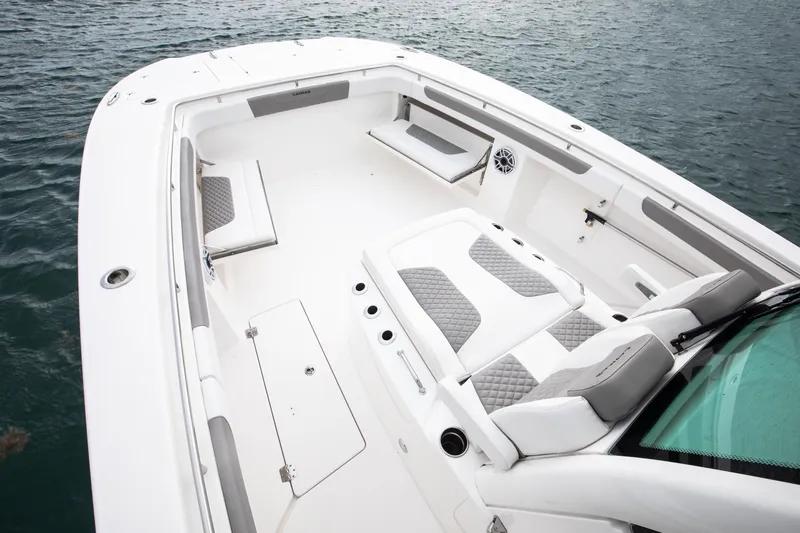 Slide: The Image of 2024 Caymas 341 CC boat interior with cushioned seating and storage compartments. - 8