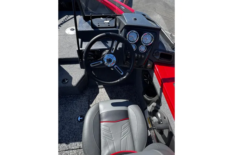 Slide: The Image of 2026 Tracker Targa V-19 WT boat interior with steering wheel and dashboard controls. - 3