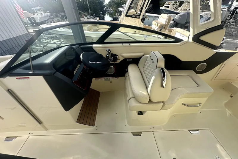 Slide: The Image of 2026 Chris-Craft Sportster 28 interior with luxurious seating and modern dashboard design. - 10