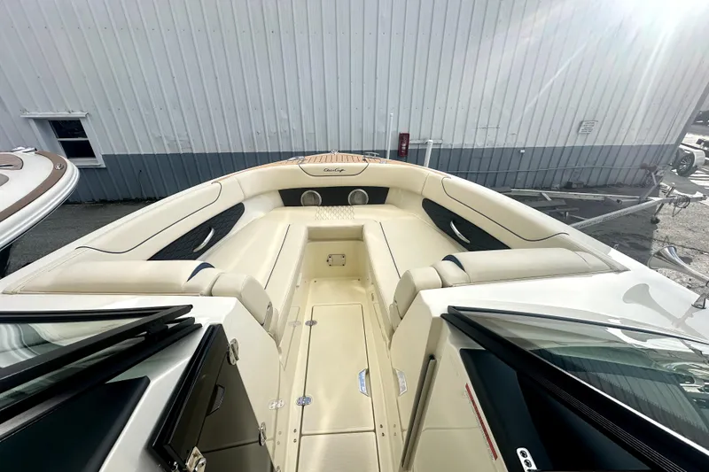 Slide: The Image of 2026 Chris-Craft Sportster 28 boat interior with beige seating and sleek design. - 12