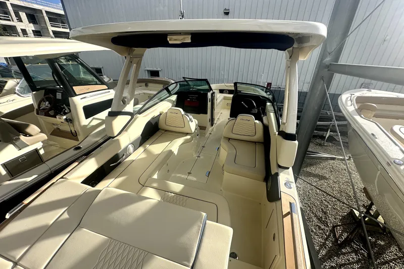 Slide: The Image of 2026 Chris-Craft Sportster 28 boat interior with beige seating and modern design. - 6