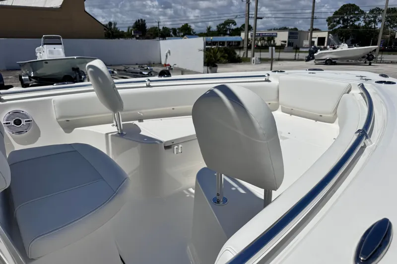 Slide: The Image of 2026 Key West 219 FS boat interior with white seating and sleek design. - 13