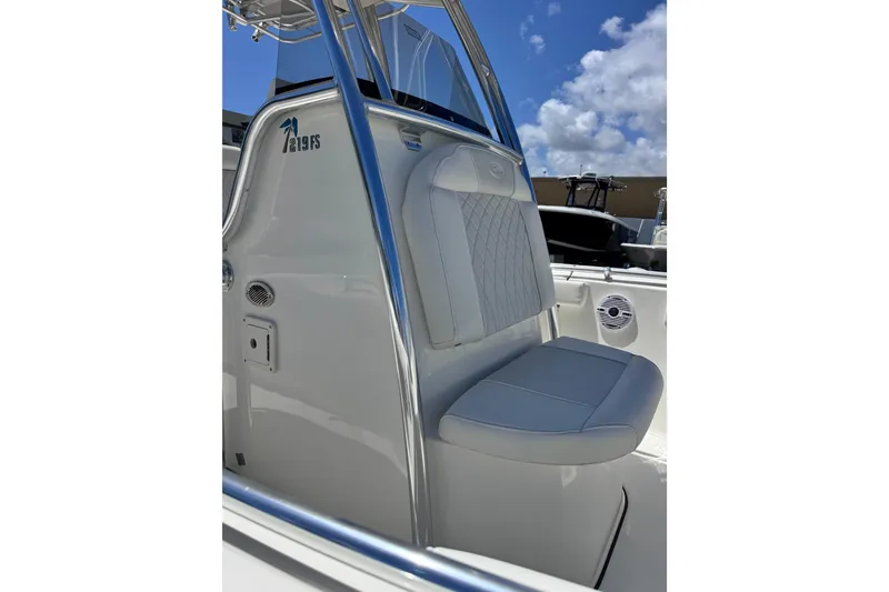 Slide: The Image of 2026 Key West 219 FS boat interior with cushioned seating and sleek design. - 14