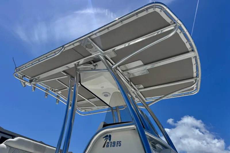 Slide: The Image of 2026 Key West 219 FS boat with T-top against a clear blue sky. - 15