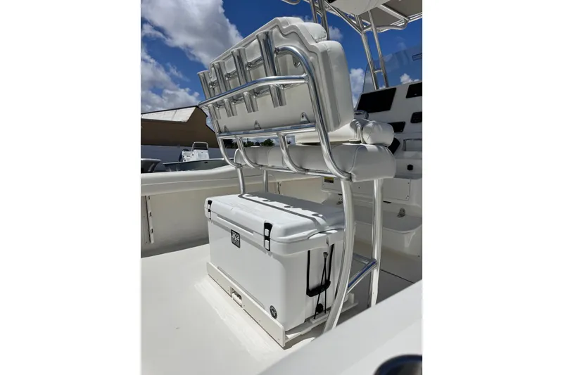Slide: The Image of 2026 Key West 219 FS boat interior with seating and cooler under a sunny sky. - 18
