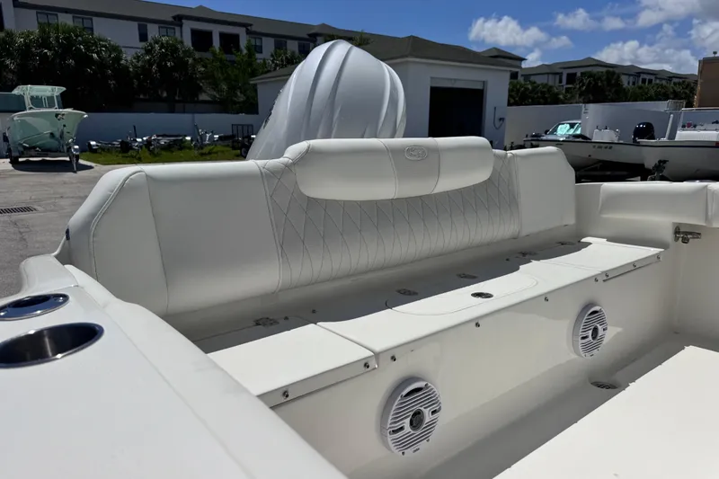 Slide: The Image of 2026 Key West 219 FS boat interior with white seating and speakers. - 19