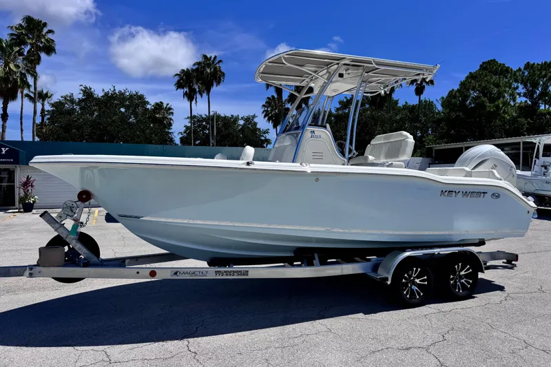 The Image of 2026 Key West 219 FS boat on trailer, parked outdoors under clear blue sky. - 7