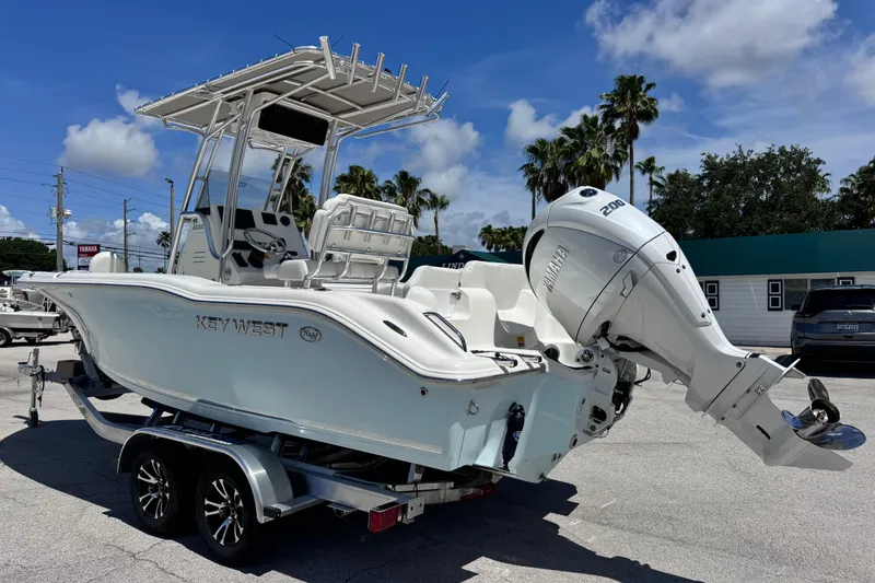 Slide: The Image of 2026 Key West 219 FS boat with Yamaha engine on trailer, parked outdoors. - 9