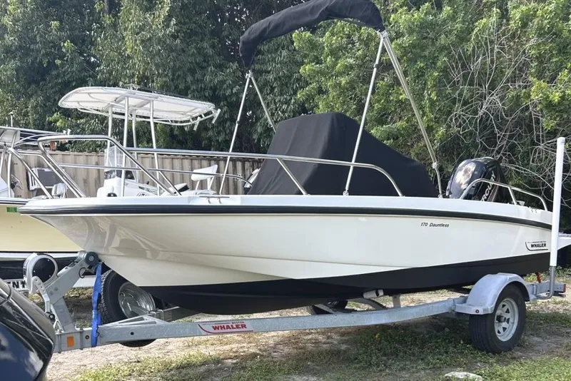 The Image of 2019 Boston Whaler 170 Dauntless boat on trailer, parked outdoors. - 1