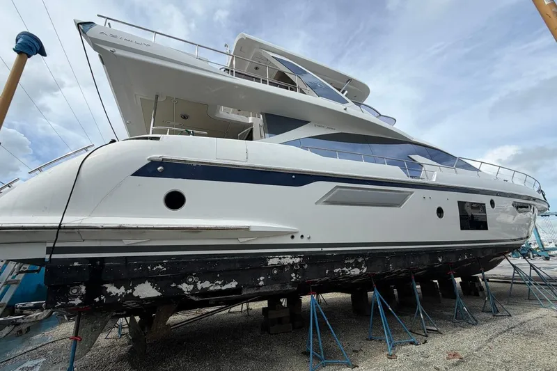 The Image of 2017 Azimut Fly 72 yacht on stands, undergoing maintenance, with a cloudy sky backdrop. - 0