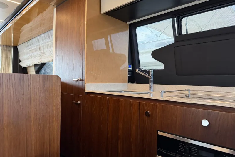 Slide: The Image of Luxurious kitchen interior of 2017 Azimut Fly 72 yacht with modern wood cabinetry. - 16