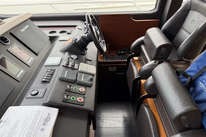 Slide: The Image of Cockpit of 2017 Azimut Fly 72 yacht with advanced navigation controls and leather seating. - 28